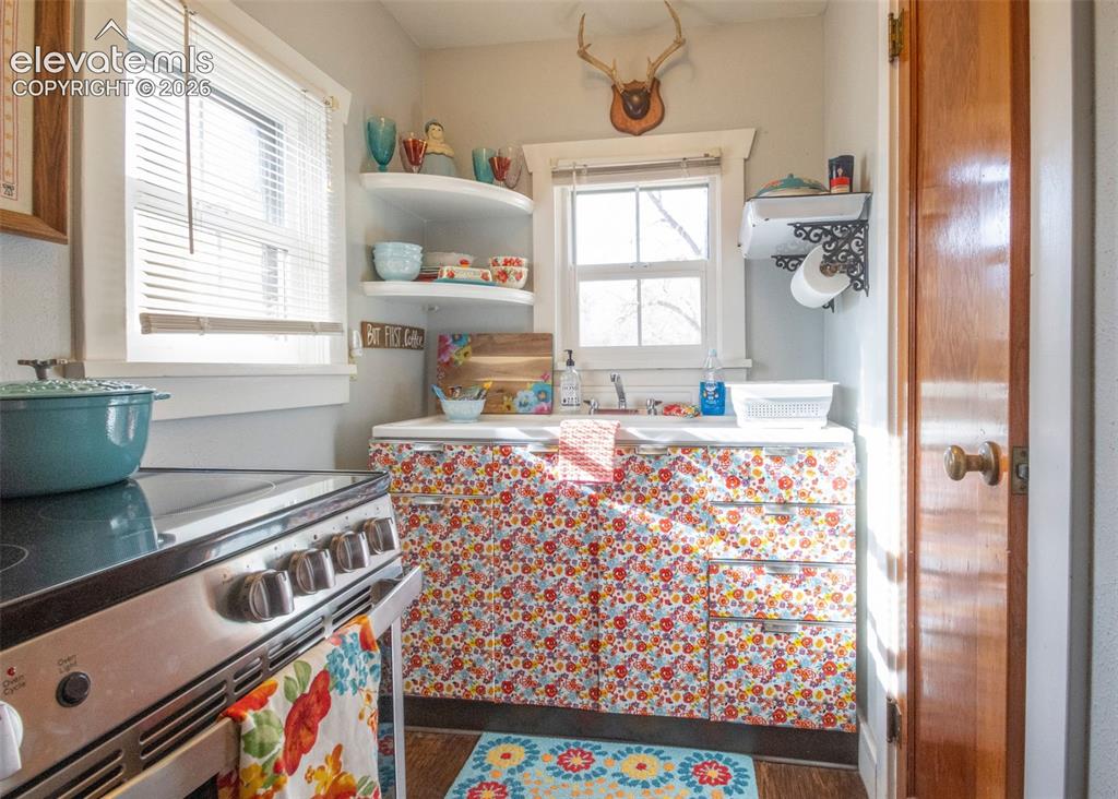 Image 31 of 50: Sweet Rose Kitchen – Efficient kitchen featuring ample cabinetry, open shel