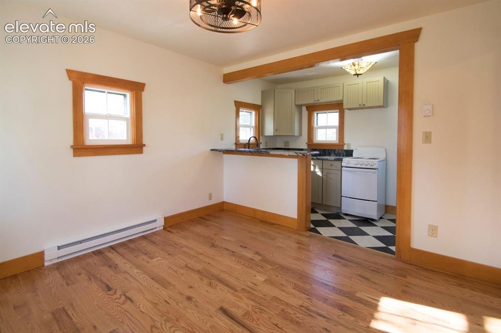 Image 35 of 50: Cottage #1 Living Area – Bright open living area with hardwood floors and s