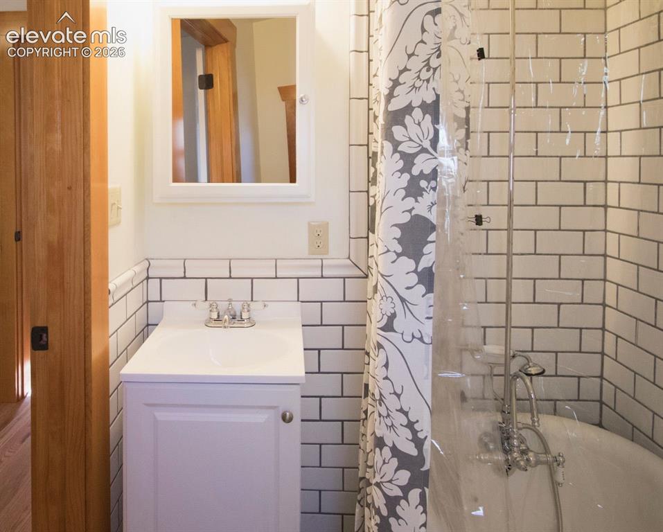 Image 37 of 50: Cottage #1 Bathroom – Updated bathroom featuring classic subway tile, moder
