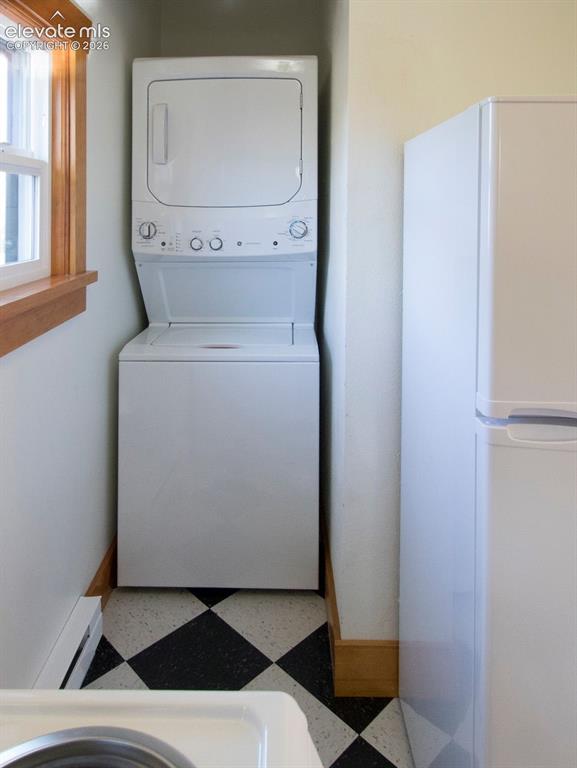 Image 38 of 50: Cottage #1 Laundry Area – Convenient in-unit stacked washer and dryer with 