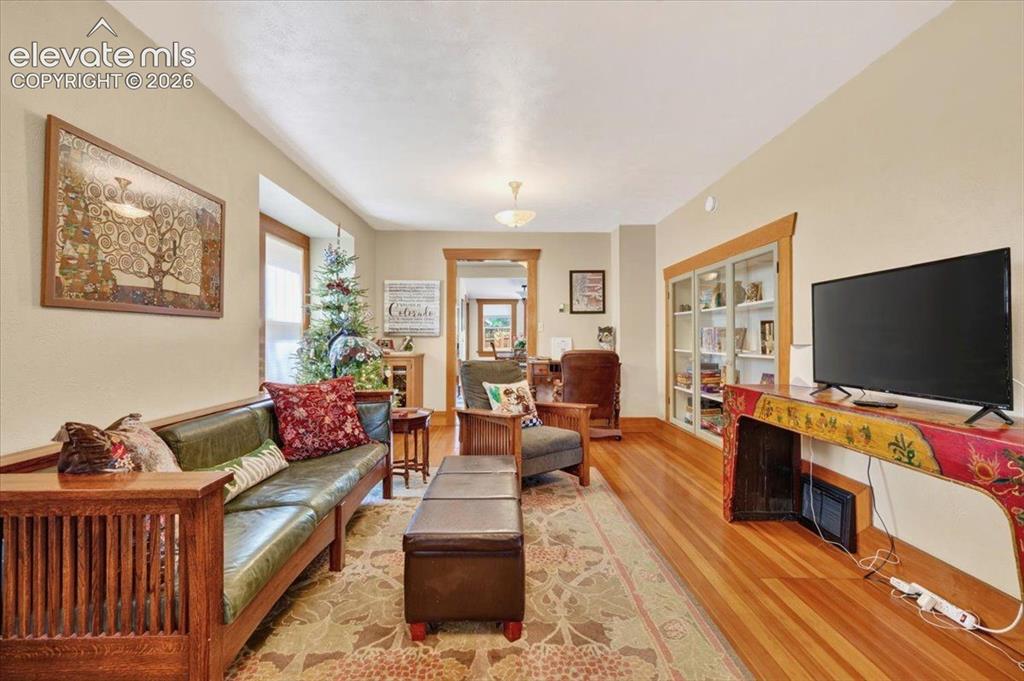 Image 4 of 50: Living Room – Bright and inviting living room featuring original hardwood f