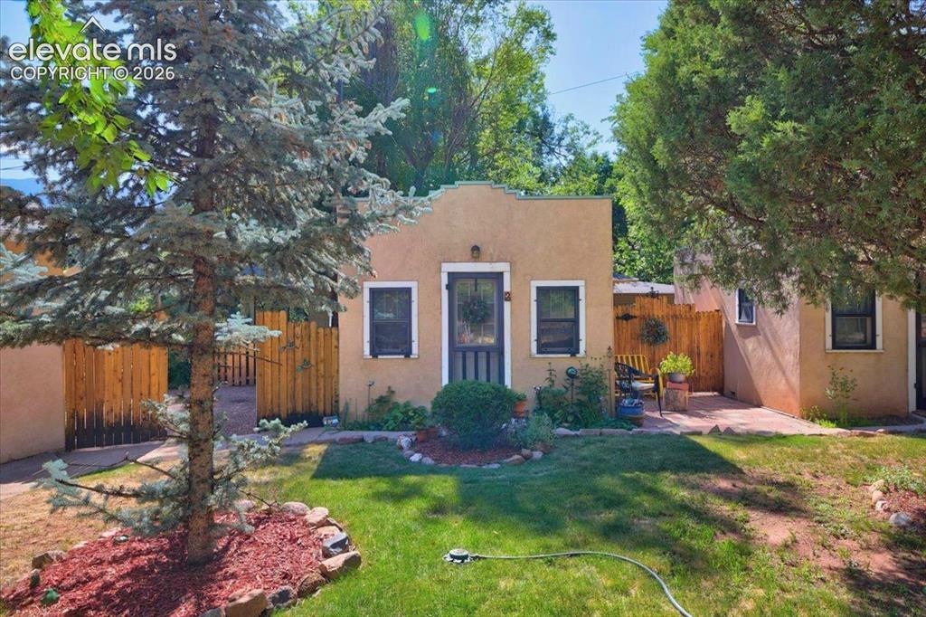 Image 40 of 50: Private Cottage #2 Exterior – Charming cottage exterior with mature landsca