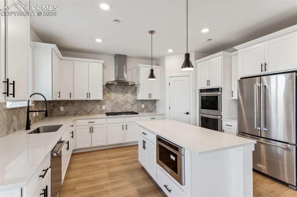 Image 5 of 17: Kitchen featuring appliances with stainless steel finishes, light wood-type