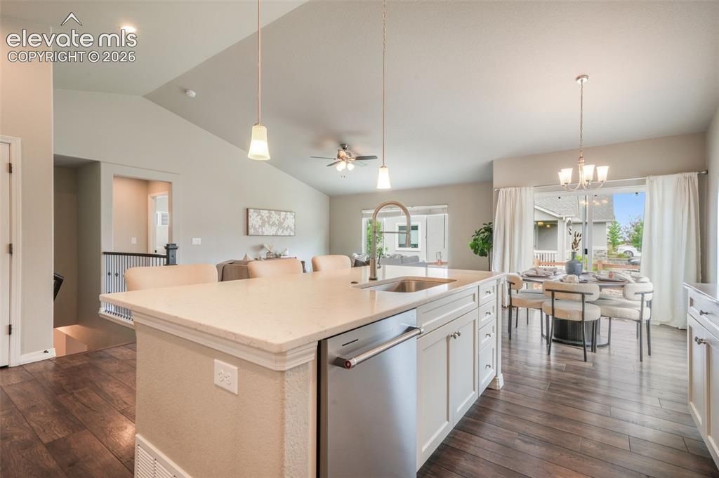 Image 10 of 49: Open-concept kitchen featuring a spacious island with an undermount sink, s