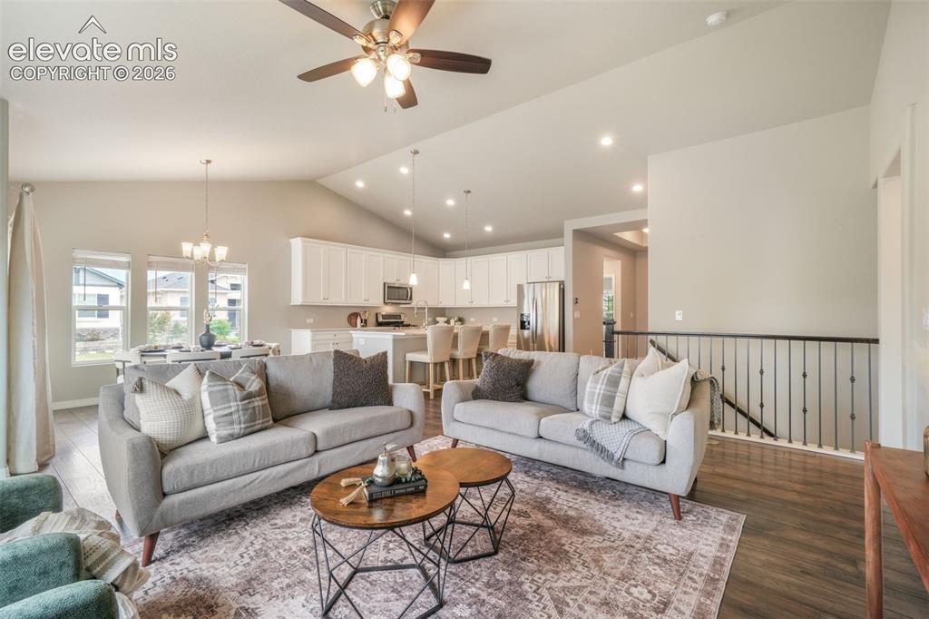 Image 17 of 49: Open-concept living space featuring vaulted ceilings and recessed lighting