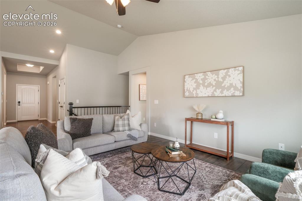 Image 18 of 49: Spacious living area featuring vaulted ceilings, recessed lighting, LVP