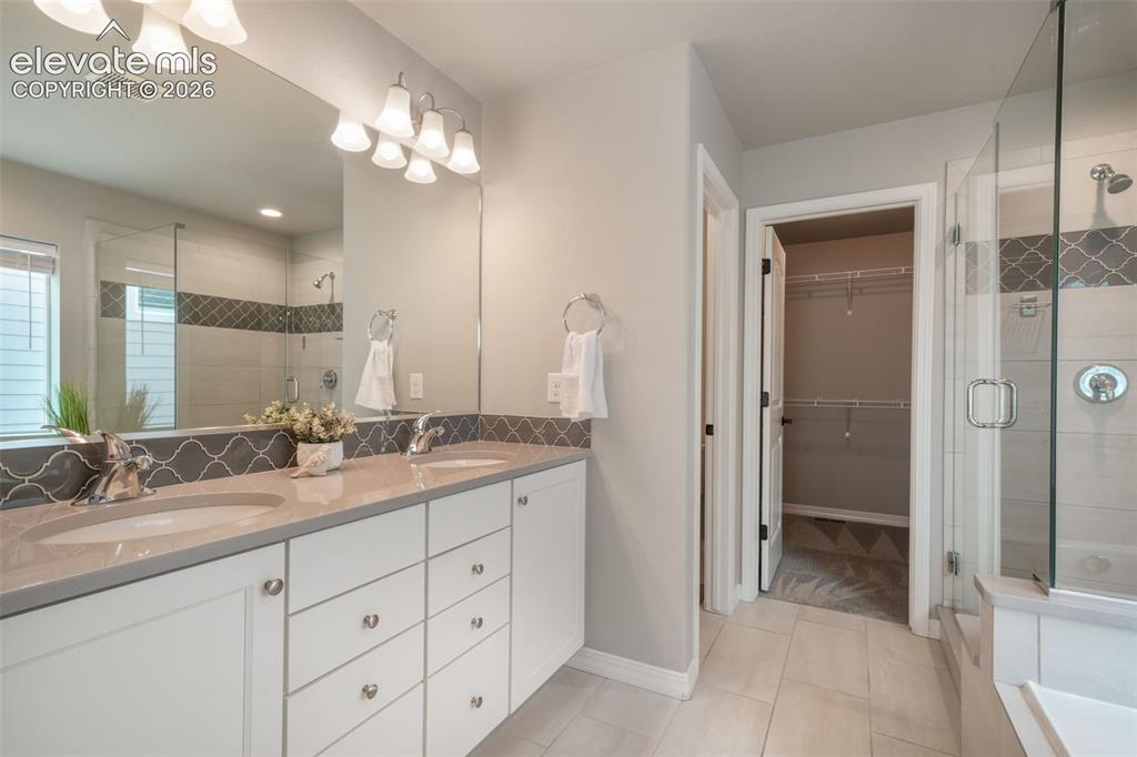 Image 26 of 49: Double vanity with integrated sinks and a light-toned countertop