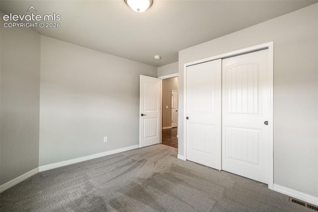 Image 31 of 49: Carpeted bedroom