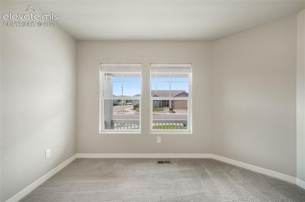 Image 32 of 49: Bright room featuring dual windows