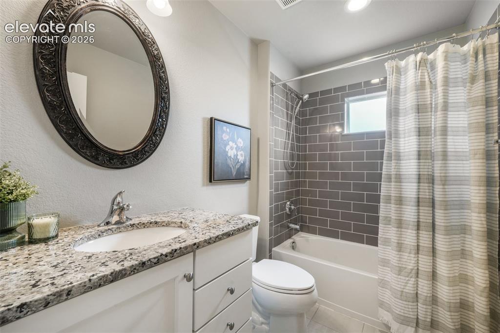Image 33 of 49: Bathroom featuring a white vanity