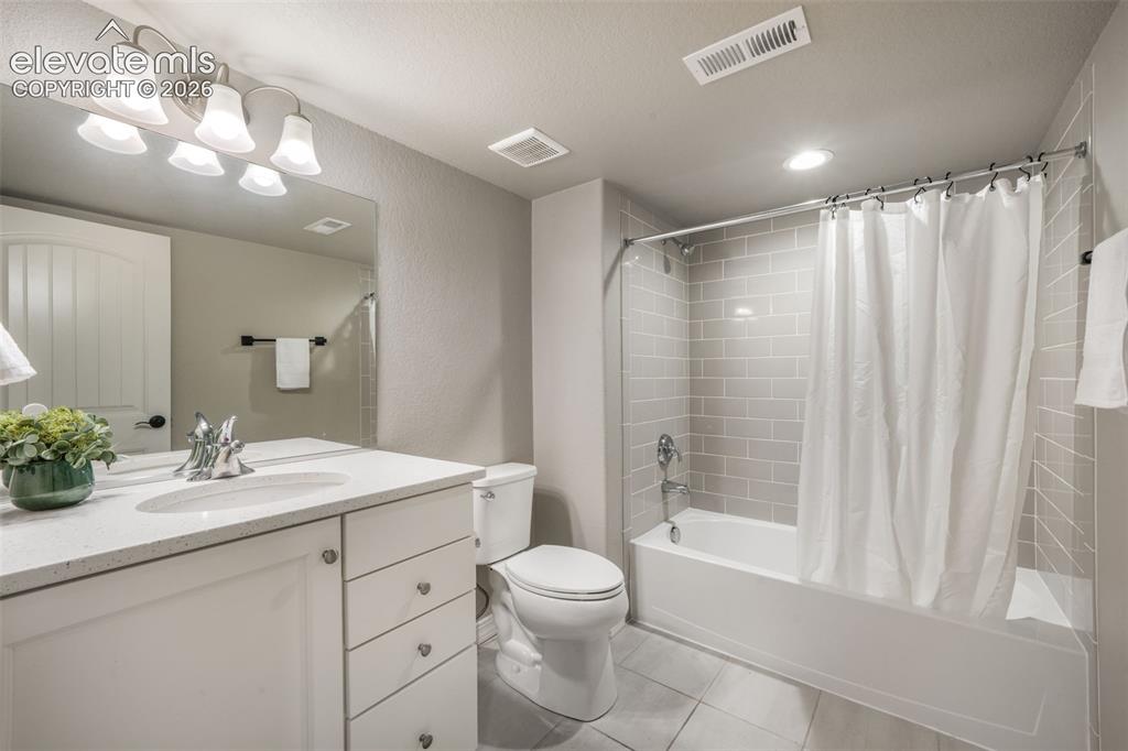 Image 40 of 49: Full bathroom featuring a white vanity