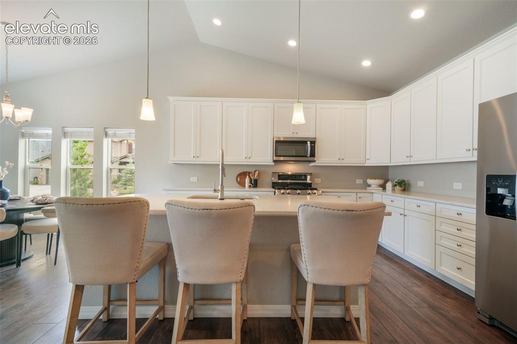 Image 8 of 49: Contemporary kitchen featuring white cabinetry, stainless steel appliances,