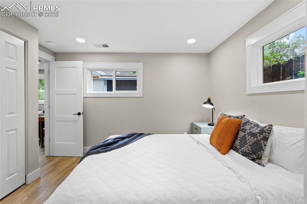 Image 11 of 15: Bedroom featuring light wood-style floors and recessed lighting