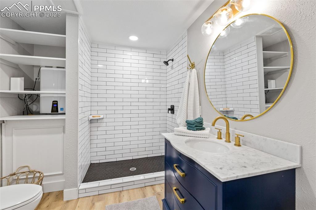 Image 14 of 15: Bathroom, has stackable washer/dryer behind door