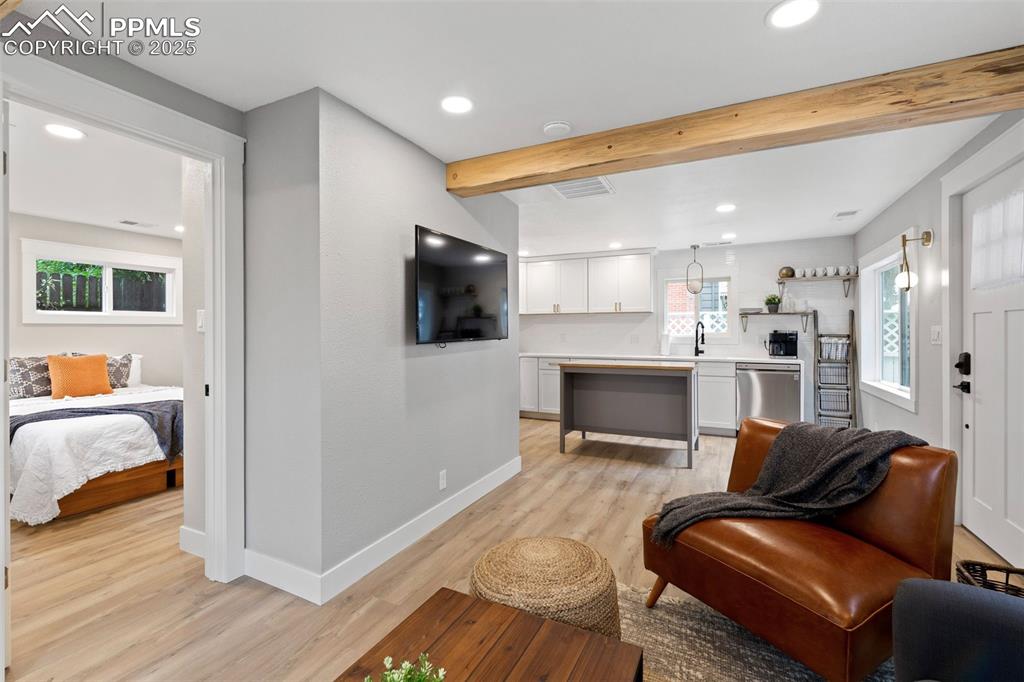 Image 6 of 15: Living area featuring recessed lighting, beam ceiling, and light wood finis