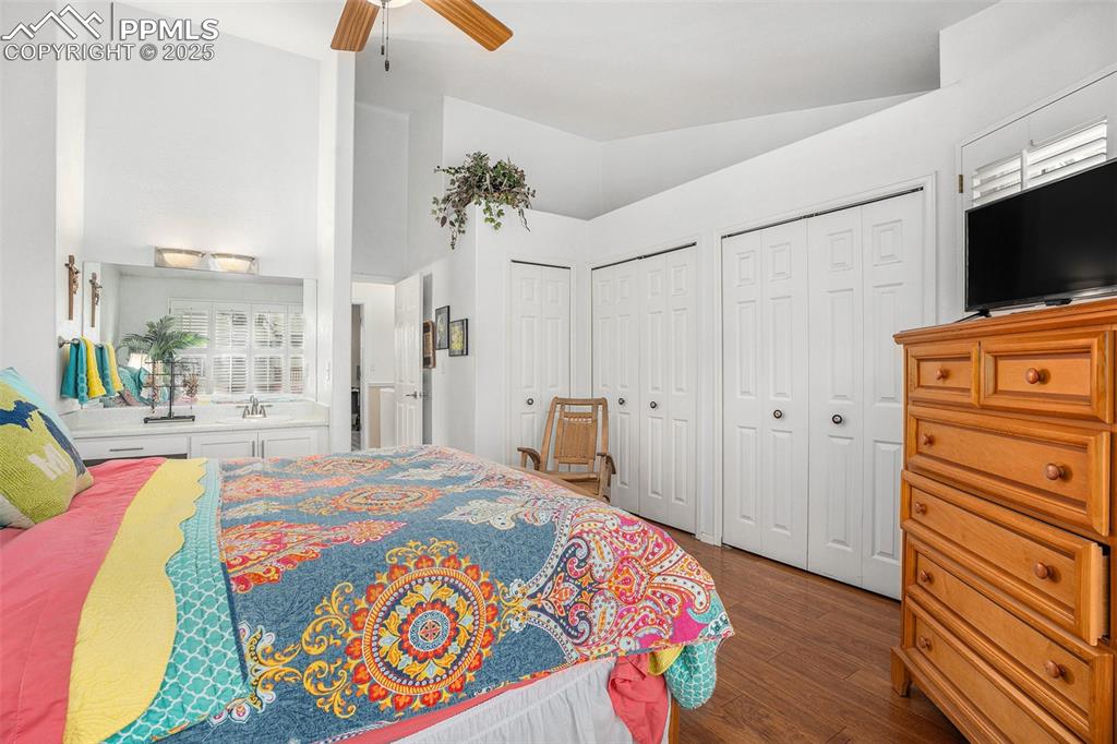 Image 10 of 23: Primary upper level bedroom with multiple closets and vanity