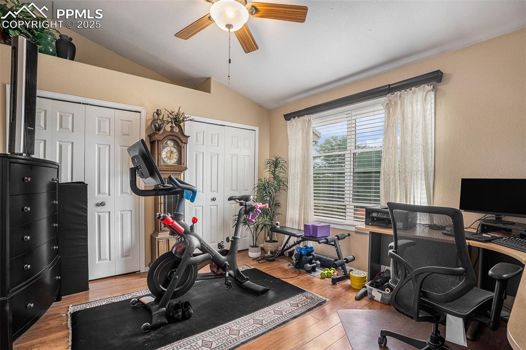 Image 12 of 23: Upper level second bedroom being used an exercise area and office with upgr
