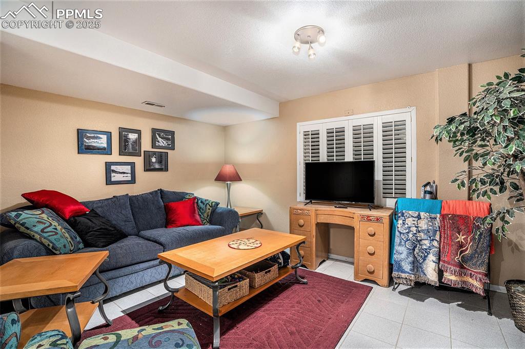 Image 14 of 23: Second living area in lower level of home could also be used as office or e