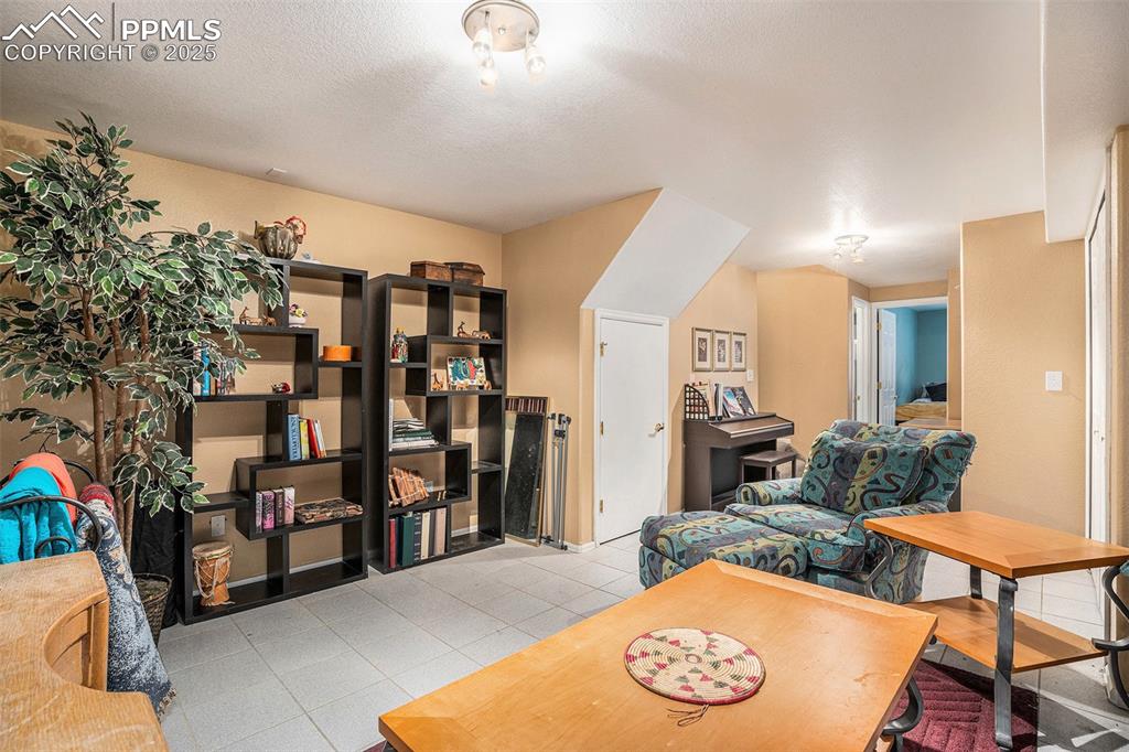 Image 15 of 23: Living area that can be second living area or office in lower level featuri