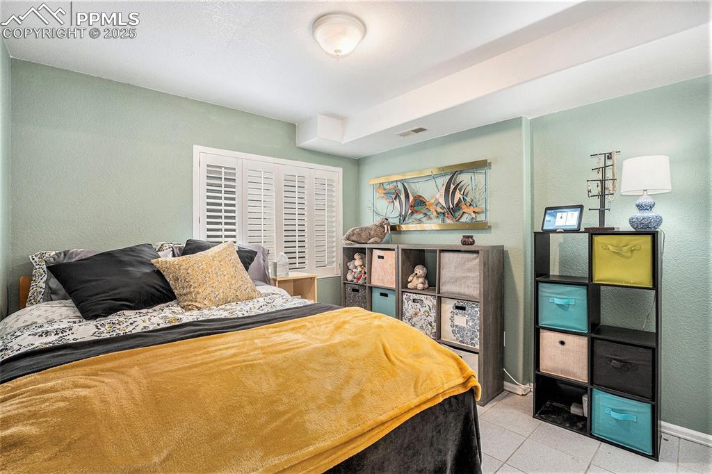 Image 17 of 23: Lower level bedroom with low maintenance flooring