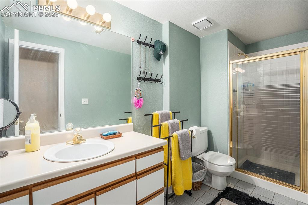 Image 18 of 23: Large 3/4 lower level bathroom featuring a shower and vanity