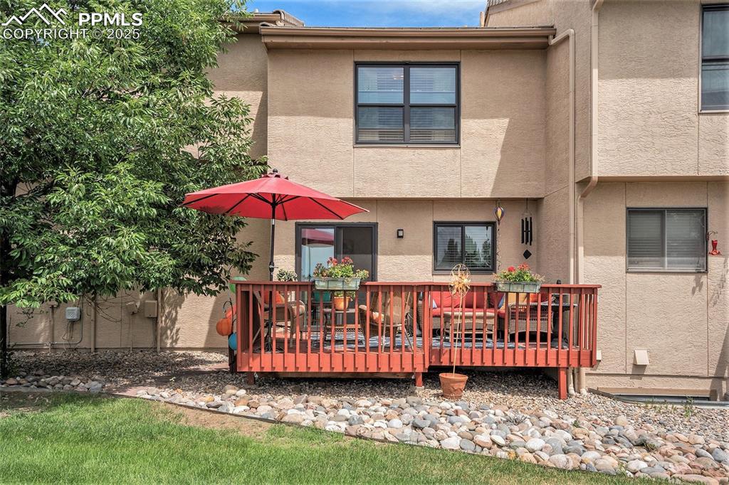 Image 20 of 23: View of extended deck on back of house. Seller added water spigot and steps