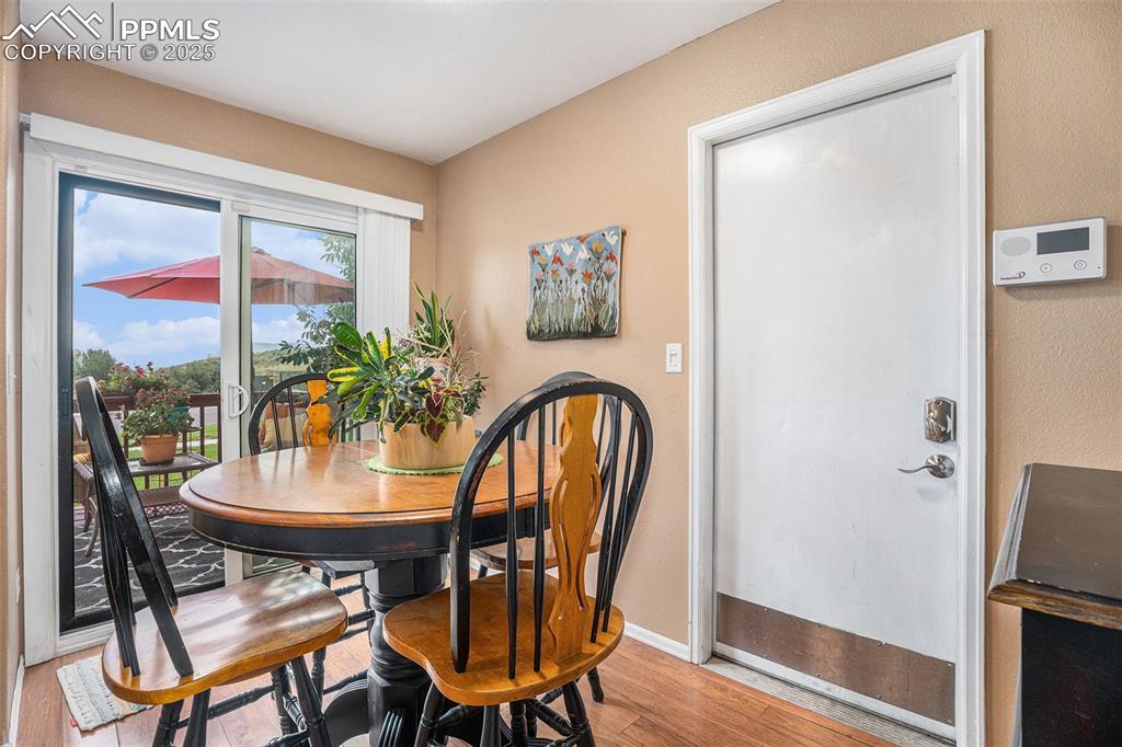 Image 5 of 23: Dining room with newer flooring which is open and bright and leads to exten