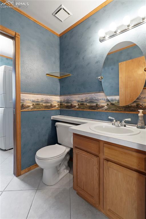 Image 14 of 46: Bathroom featuring tiled floors, a vanity with a white countertop and basin