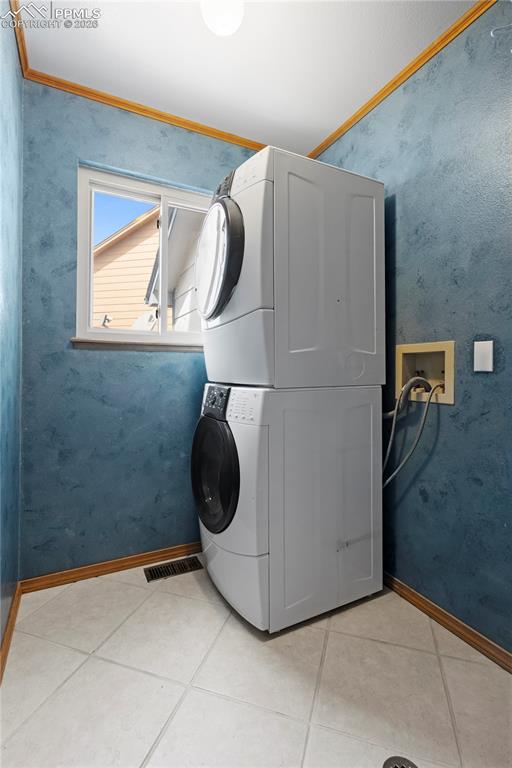 Image 15 of 46: Dedicated laundry area with tile flooring, and a window for natural light