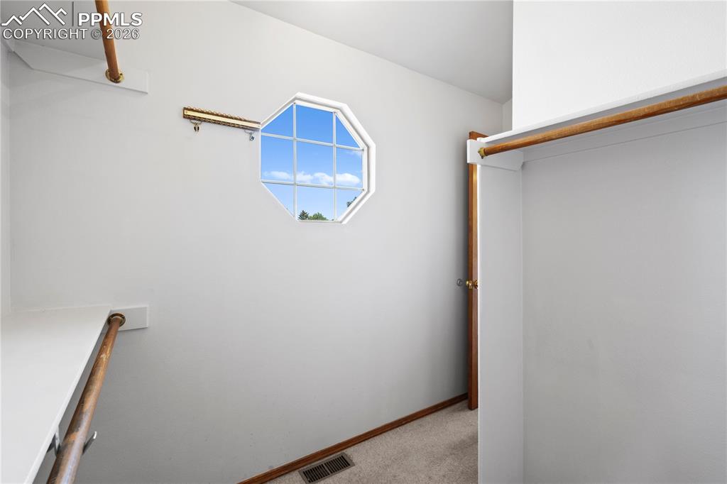 Image 19 of 46: Primary closet 