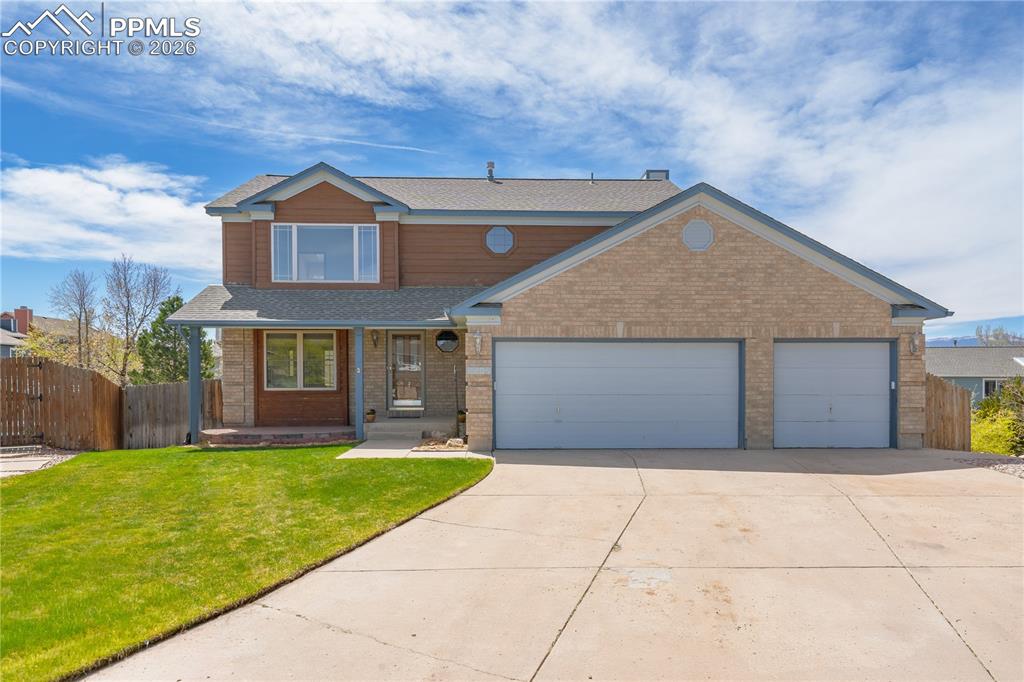 Image 2 of 46: The property features a two-story exterior with a two-car garage, a concret