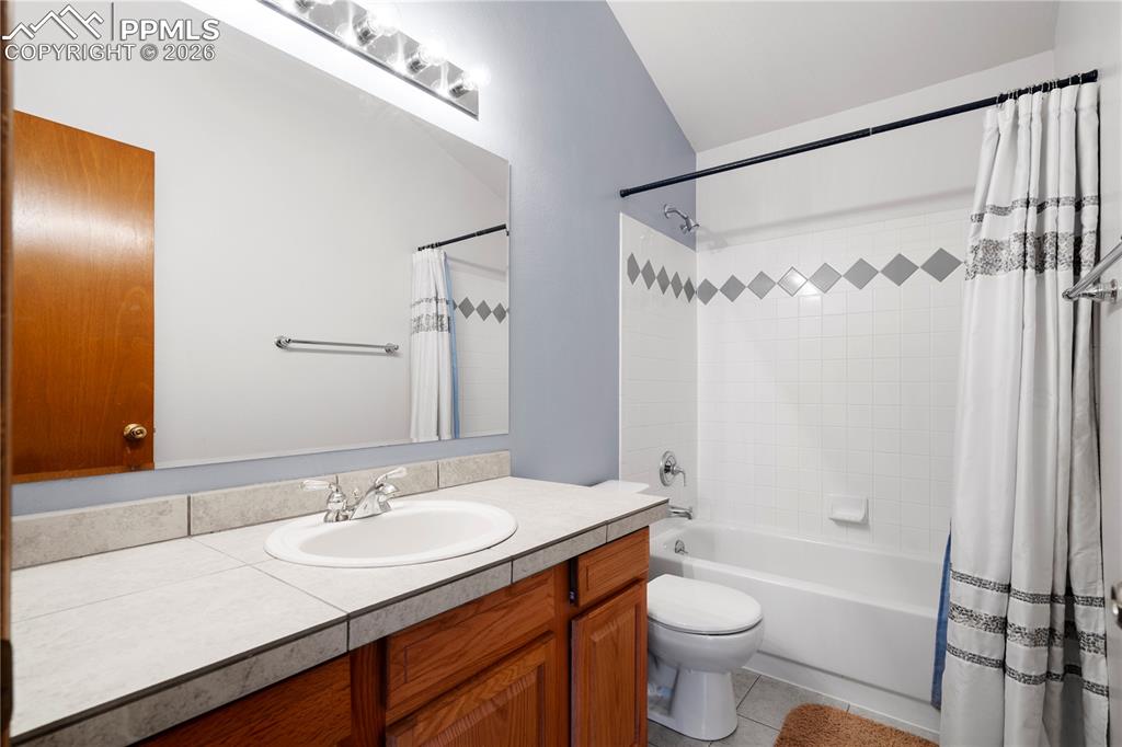 Image 23 of 46: Second Bathroom on Upper Level featuring a vanity with a tiled countertop, 