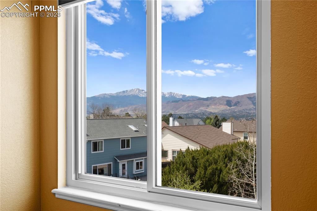 Image 28 of 46: Window offering views of distant mountains and local rooftops