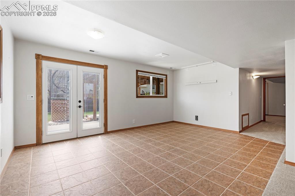Image 31 of 46: This versatile room features durable tile flooring, a window providing natu
