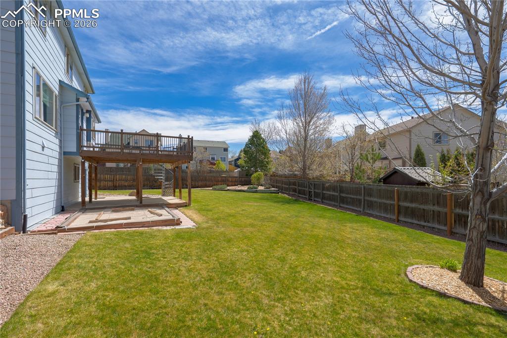 Image 36 of 46: The property features a spacious backyard with a well-maintained lawn and a