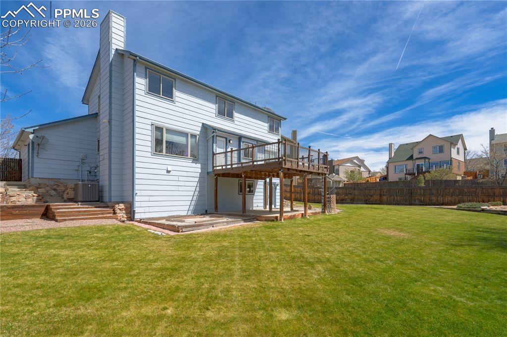 Image 37 of 46: The property features a spacious rear yard with a well-maintained lawn and 