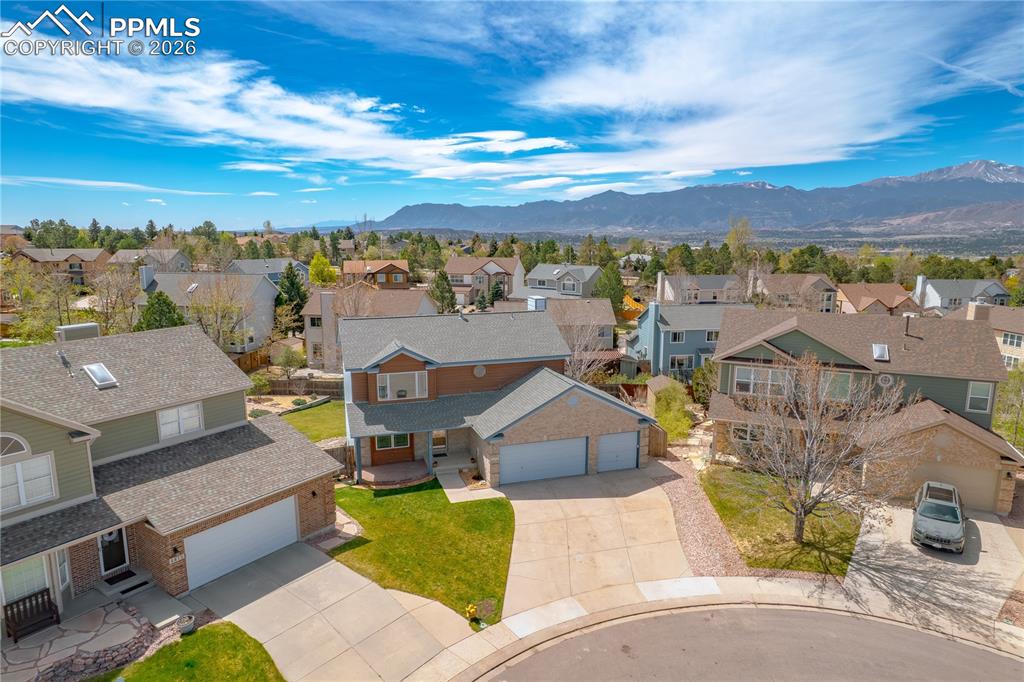 Image 43 of 46: The property features a two-story design with a two-car garage and a well-m