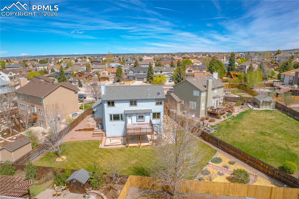 Image 44 of 46: Aerial view of the property, deck, and a fenced yard with a lawn