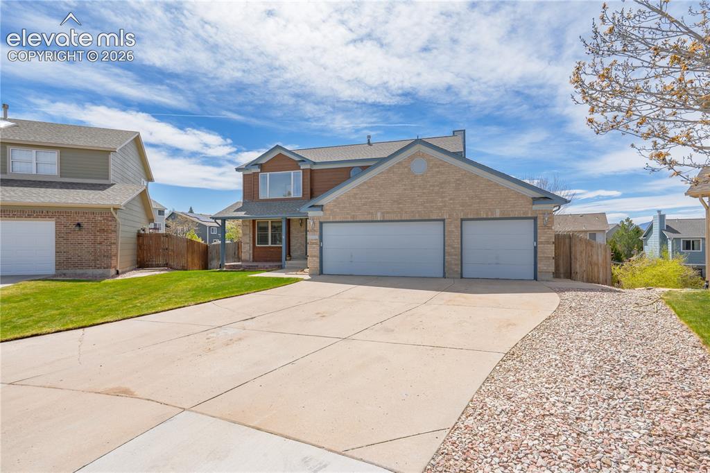 Image 49 of 49: The property features a brick and siding exterior, a two-car garage, a conc