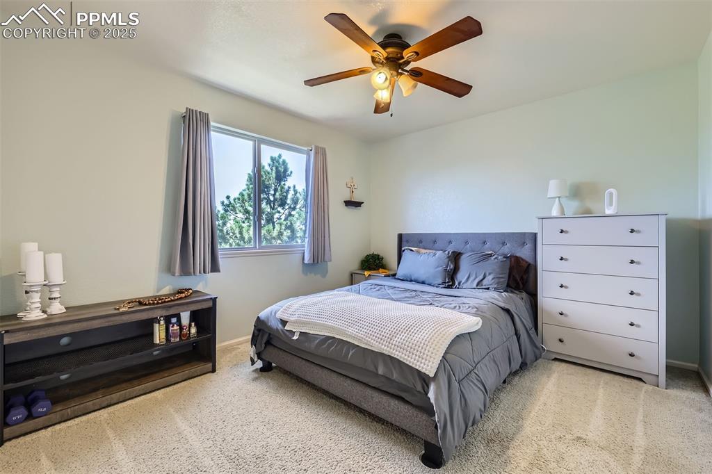 Image 13 of 30: Bedroom featuring light colored carpet and ceiling fan