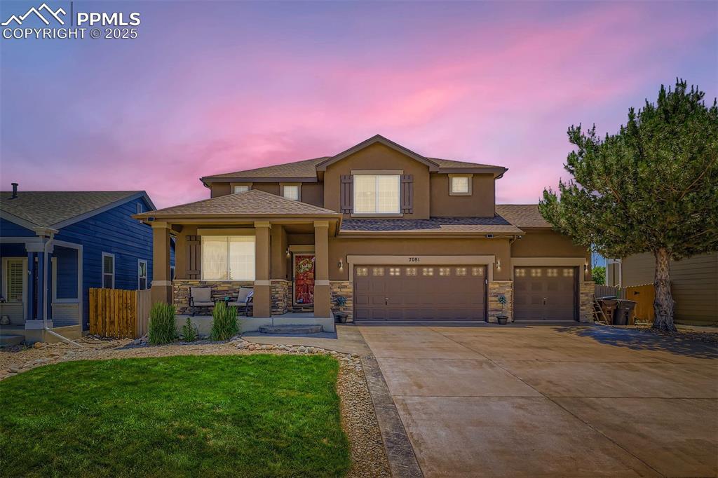 Image 2 of 30: View of front of house featuring stucco siding, covered porch, concrete dri