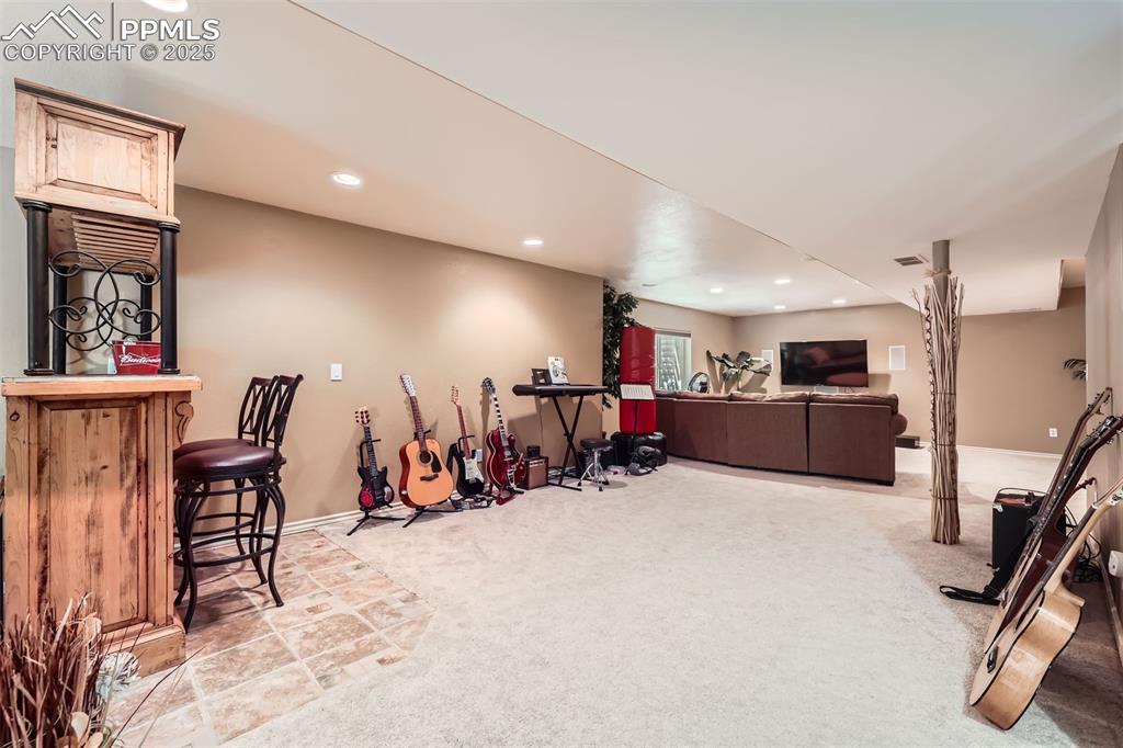 Image 27 of 30: Recreation room with carpeted floors 