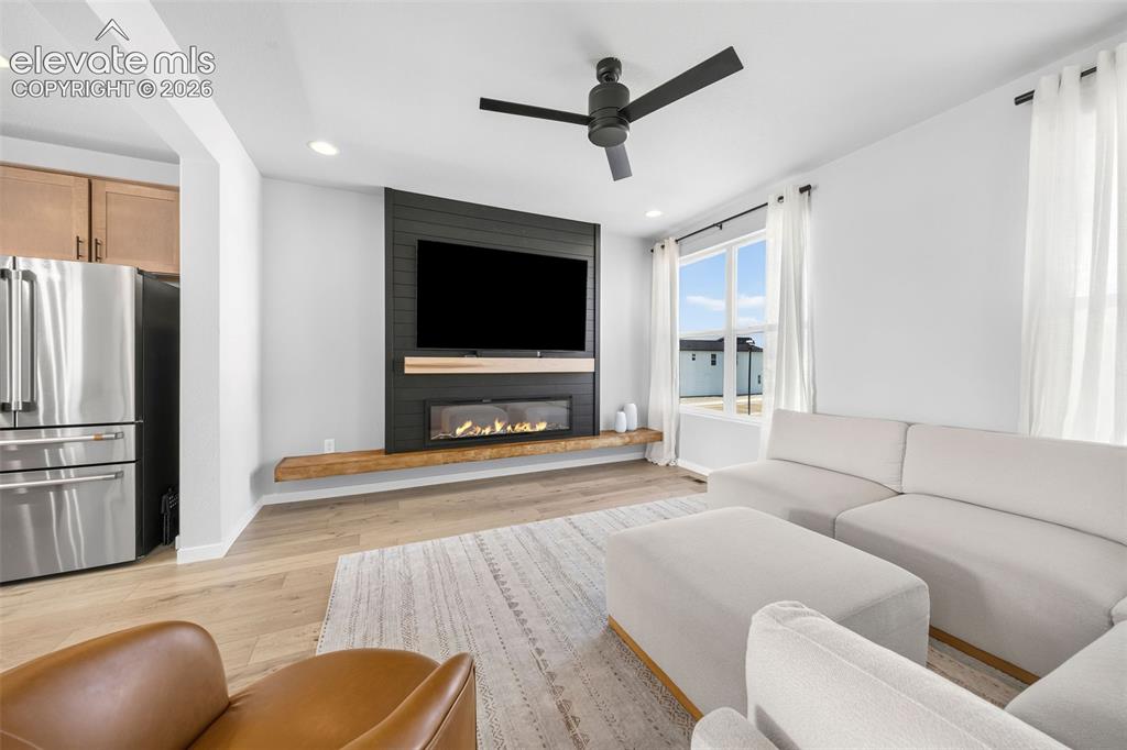 Image 12 of 48: The feature wall is the perfect spot for your big-screen TV. Enjoy the fire