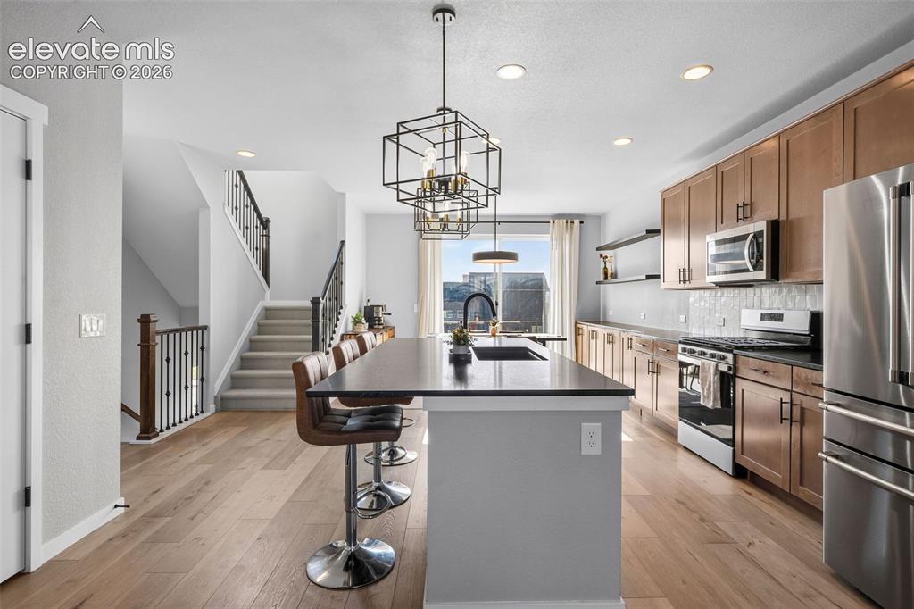 Image 13 of 48: View of the kitchen from the living room. Grab a snack without missing a be