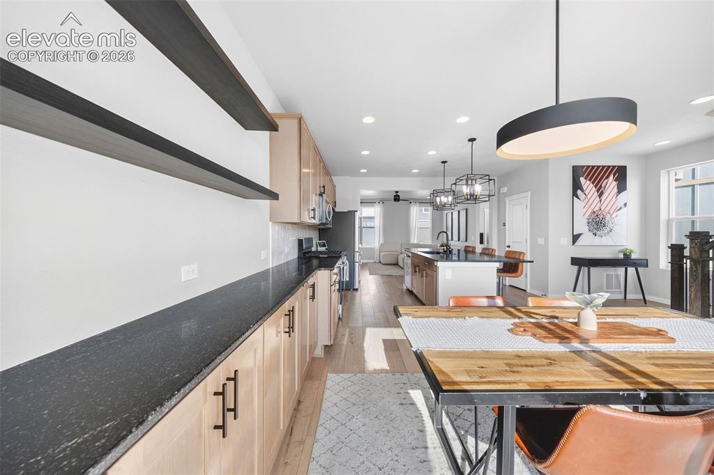 Image 18 of 48: View of the dining area, kitchen and living room from the balcony entrance.