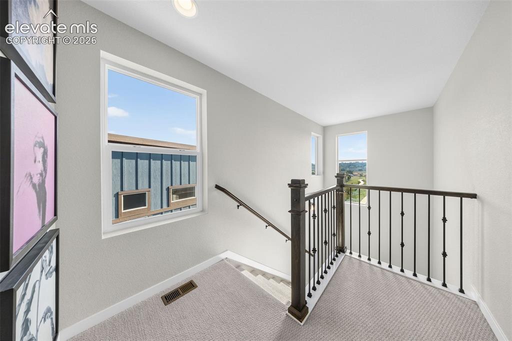 Image 22 of 48: Abundant windows keep the stairwell bright and allow views of the park just