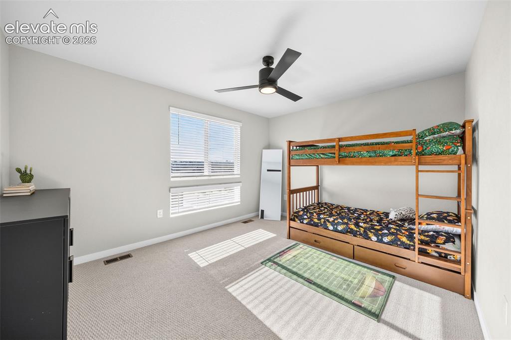 Image 24 of 48: The front-facing upstairs bedroom has its
