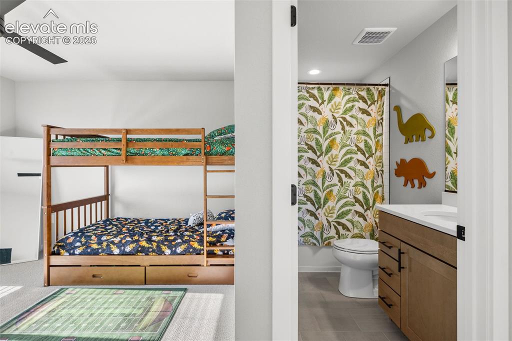 Image 25 of 48: The front-facing upstairs bedroom is bright and spacious and has a private,