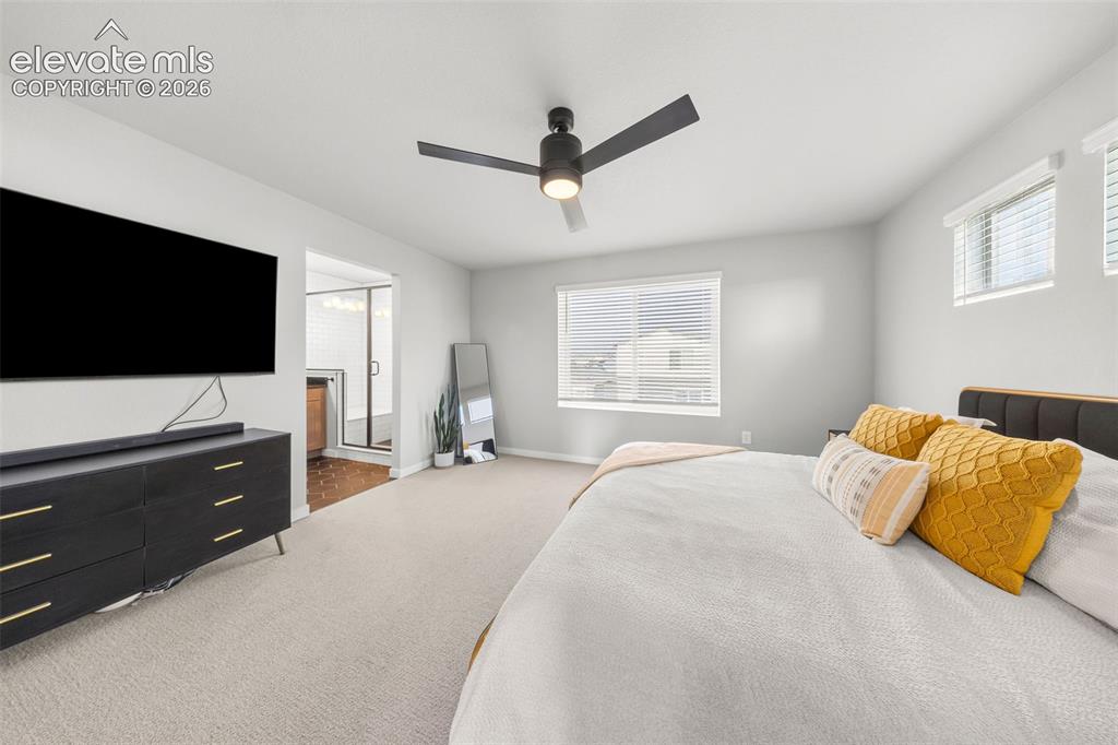 Image 28 of 48: The primary bedroom is HUGE with lots of natural light and an ensuite bath.