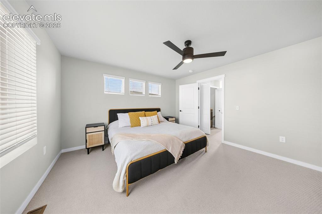 Image 29 of 48: The primary suite has an adjacent laundry area and is the perfect spot to s